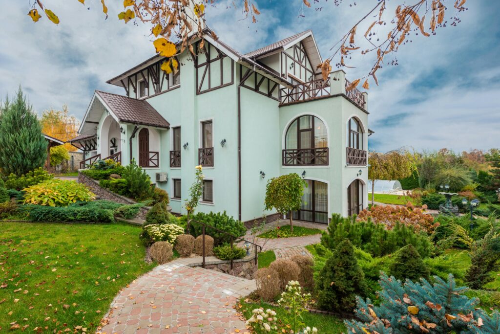 Beautiful traditional house with a garden in autumn showcasing architecture and landscaping.